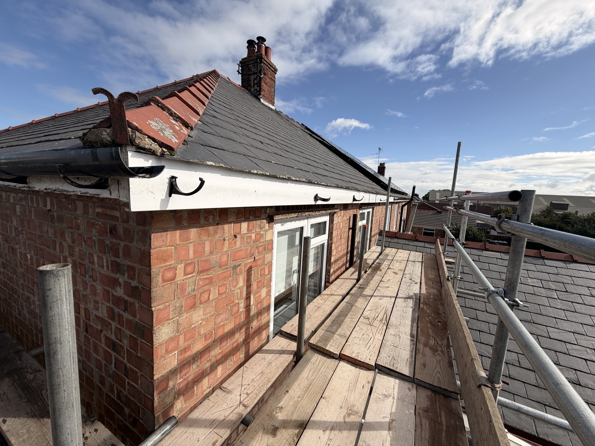 Brick side elevation and existing roof viewed from scaffold