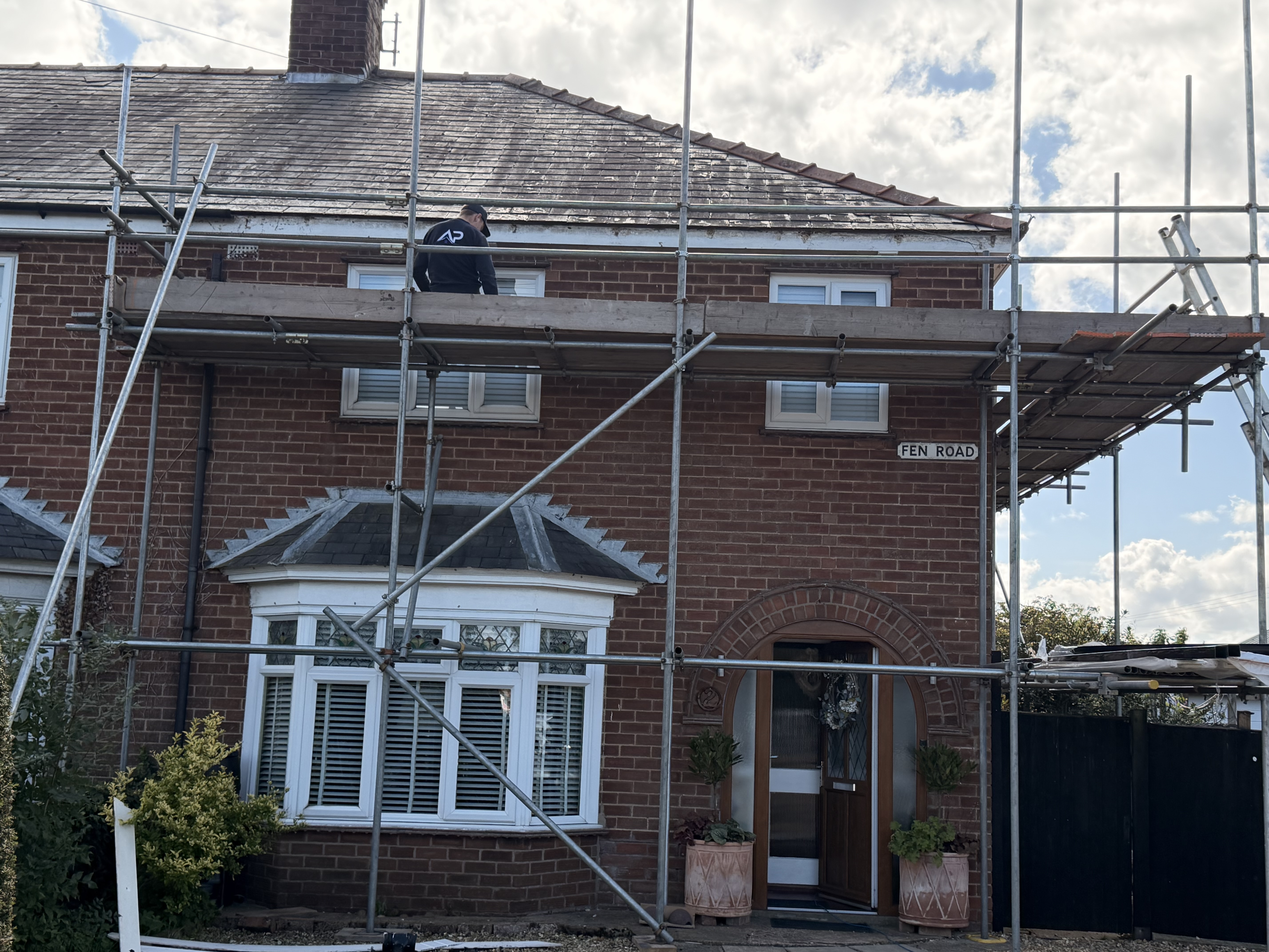 Scaffolded front elevation of a brick terrace roof