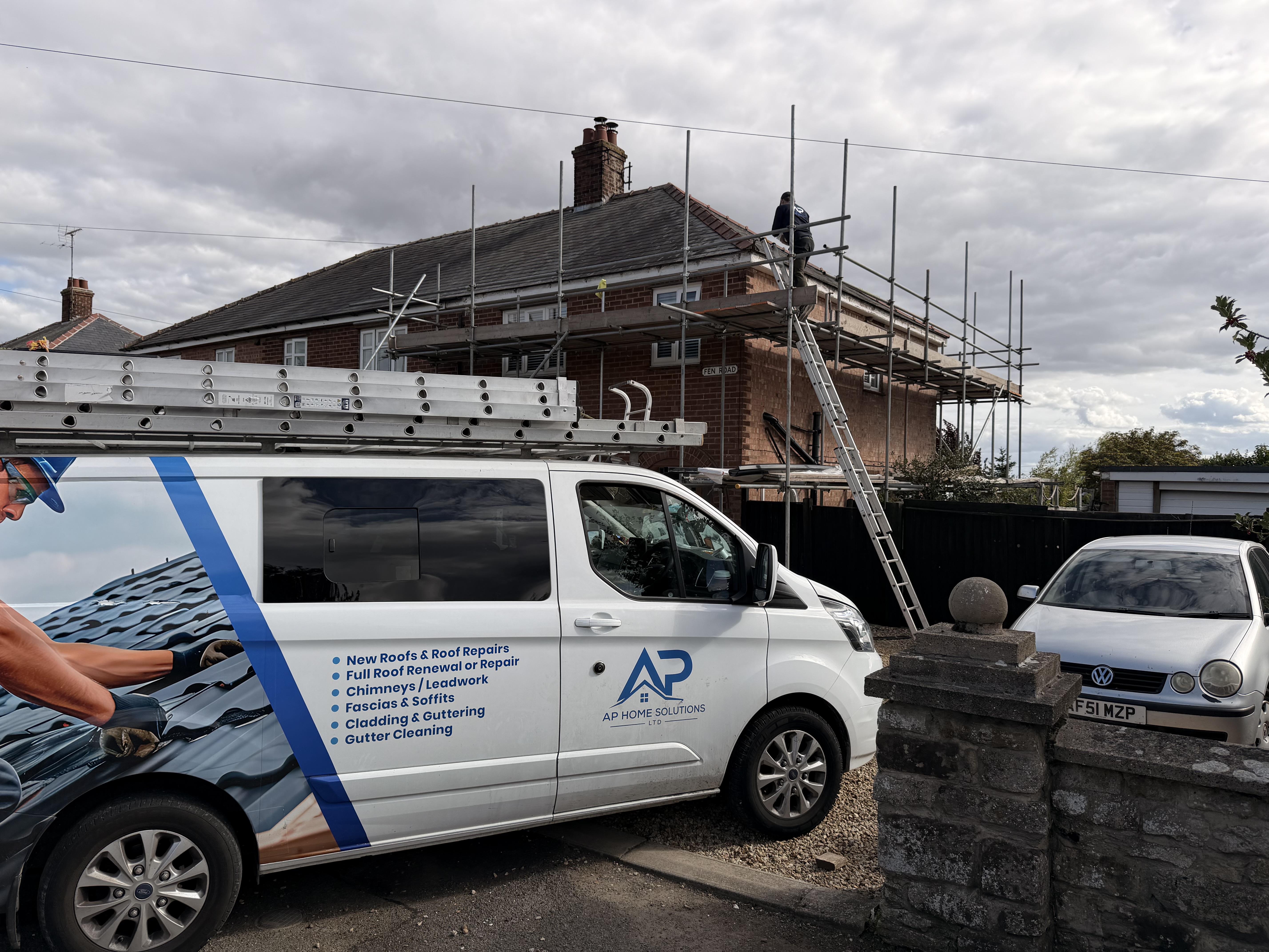 Scaffolded residential roof viewed from the street