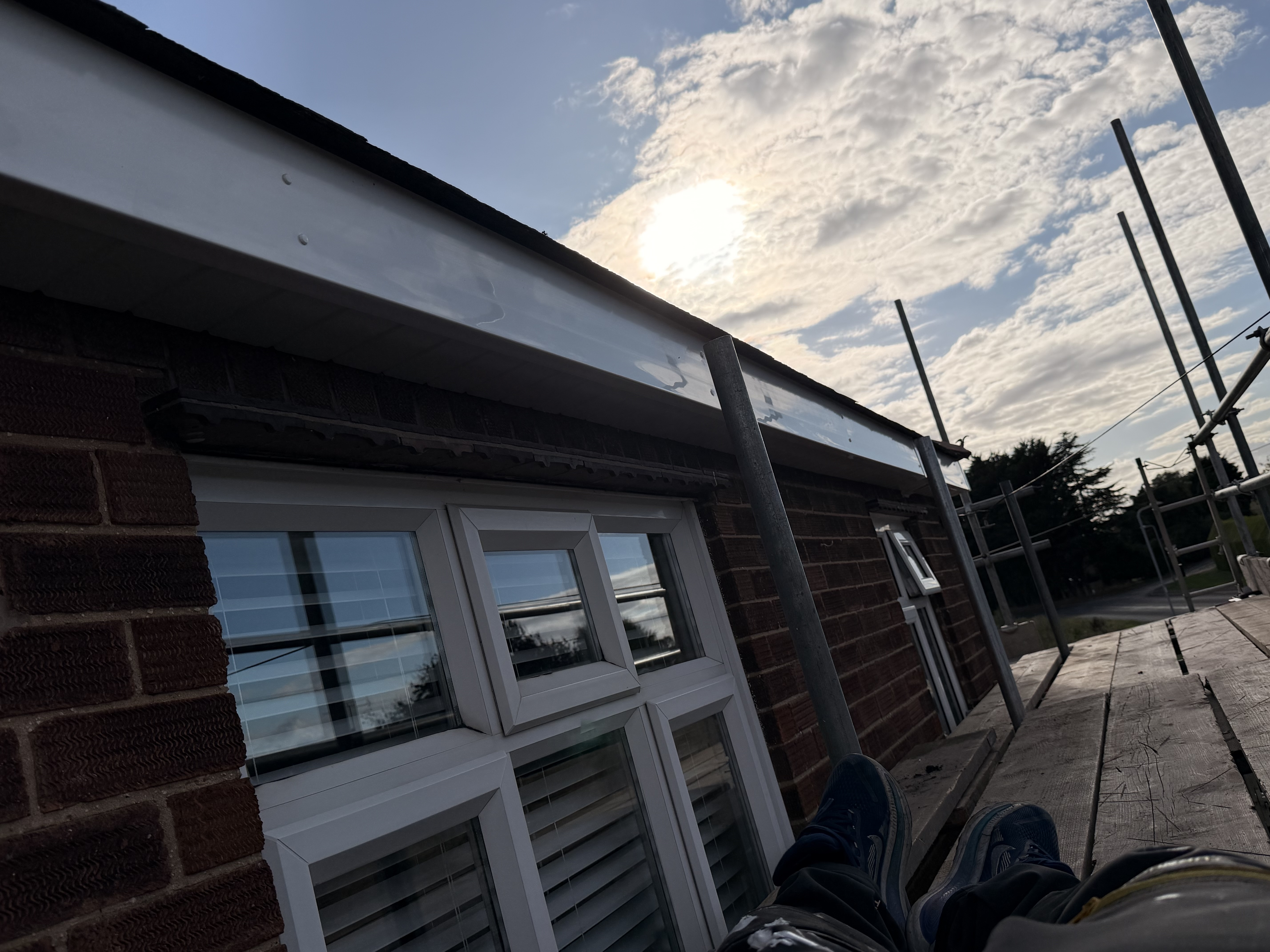 Dark roof edge and white roofline above a side elevation
