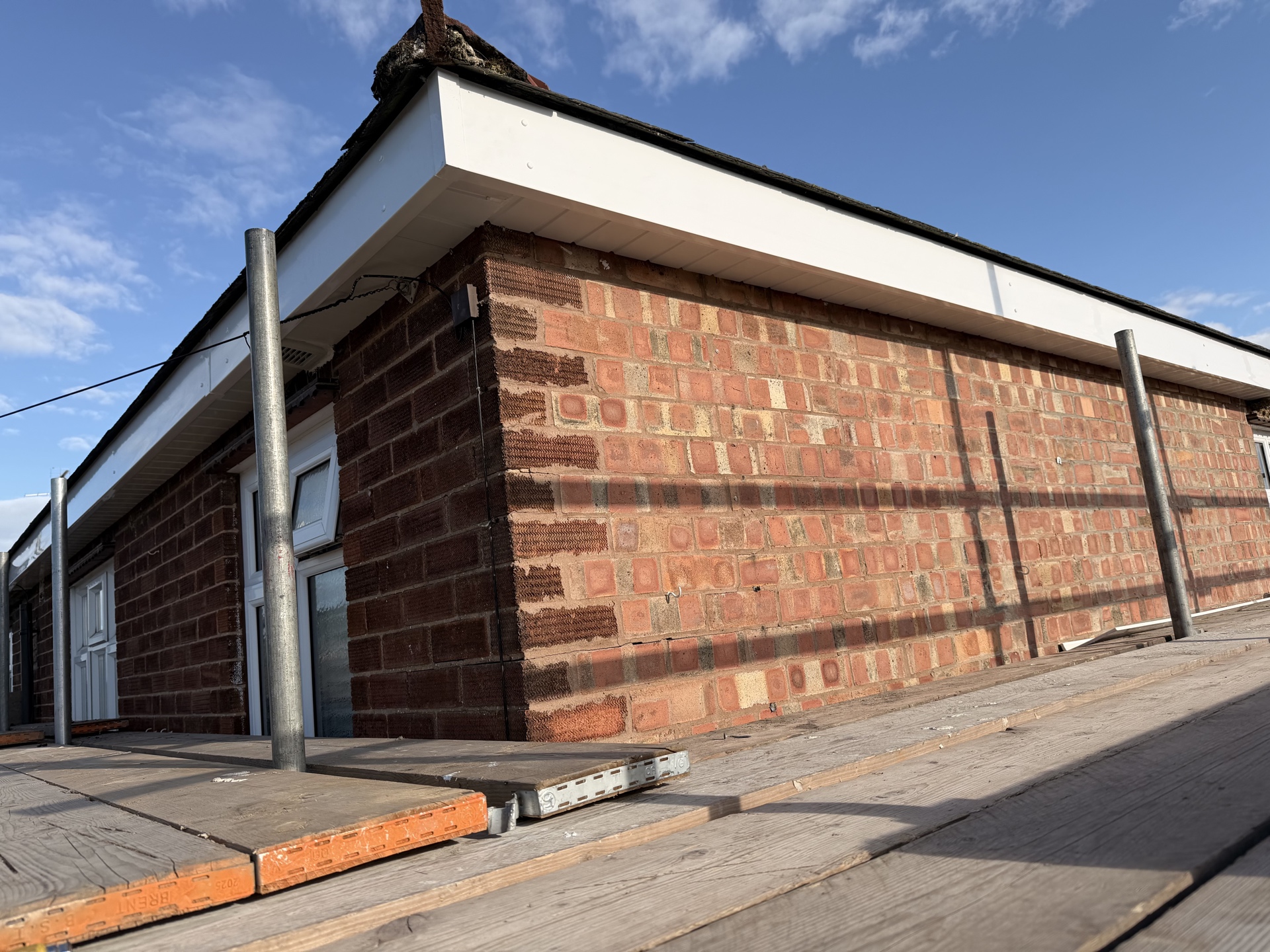 Clean roof edge and brick side elevation