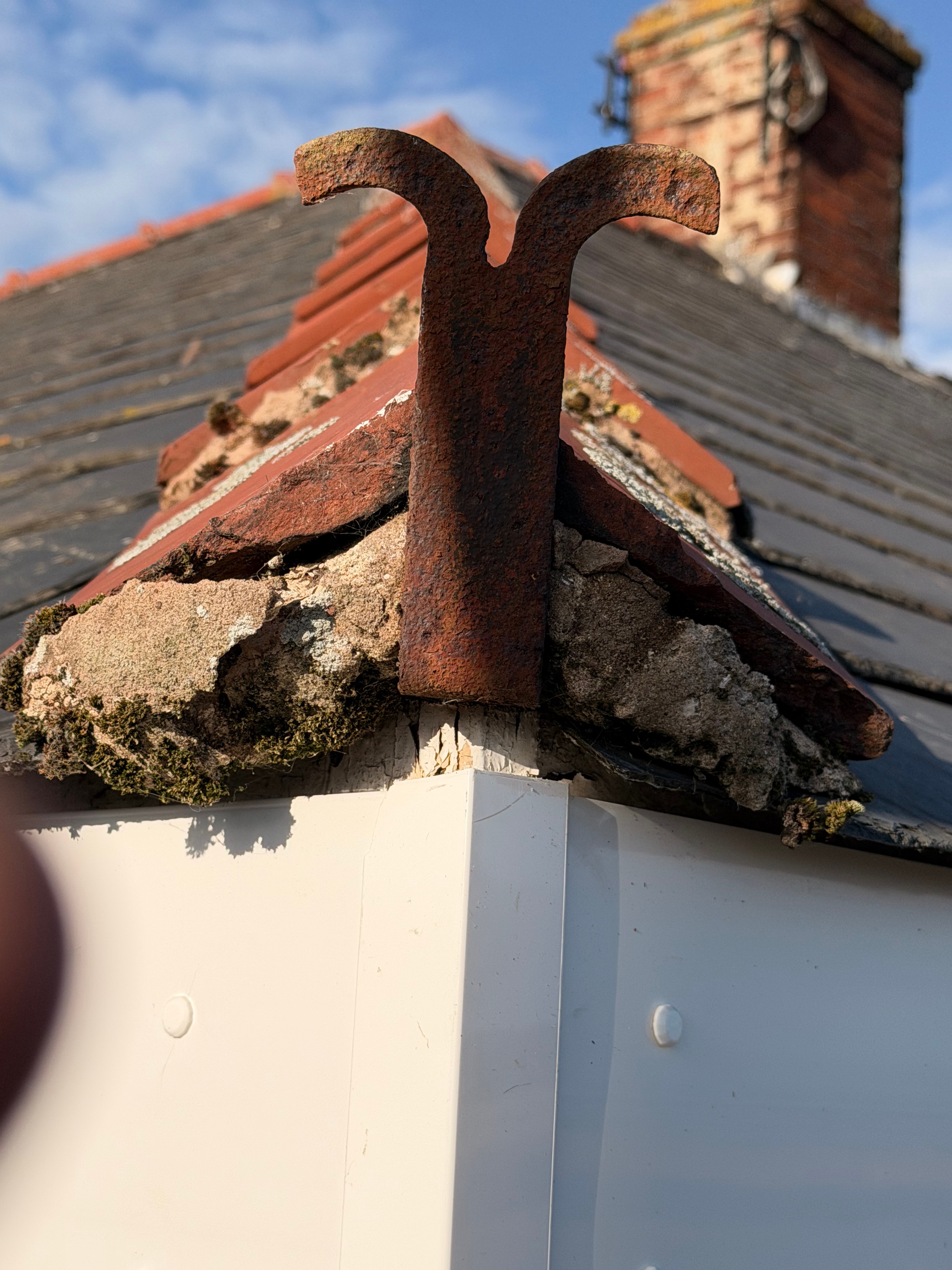 Close detail of a weathered chimney and roof junction