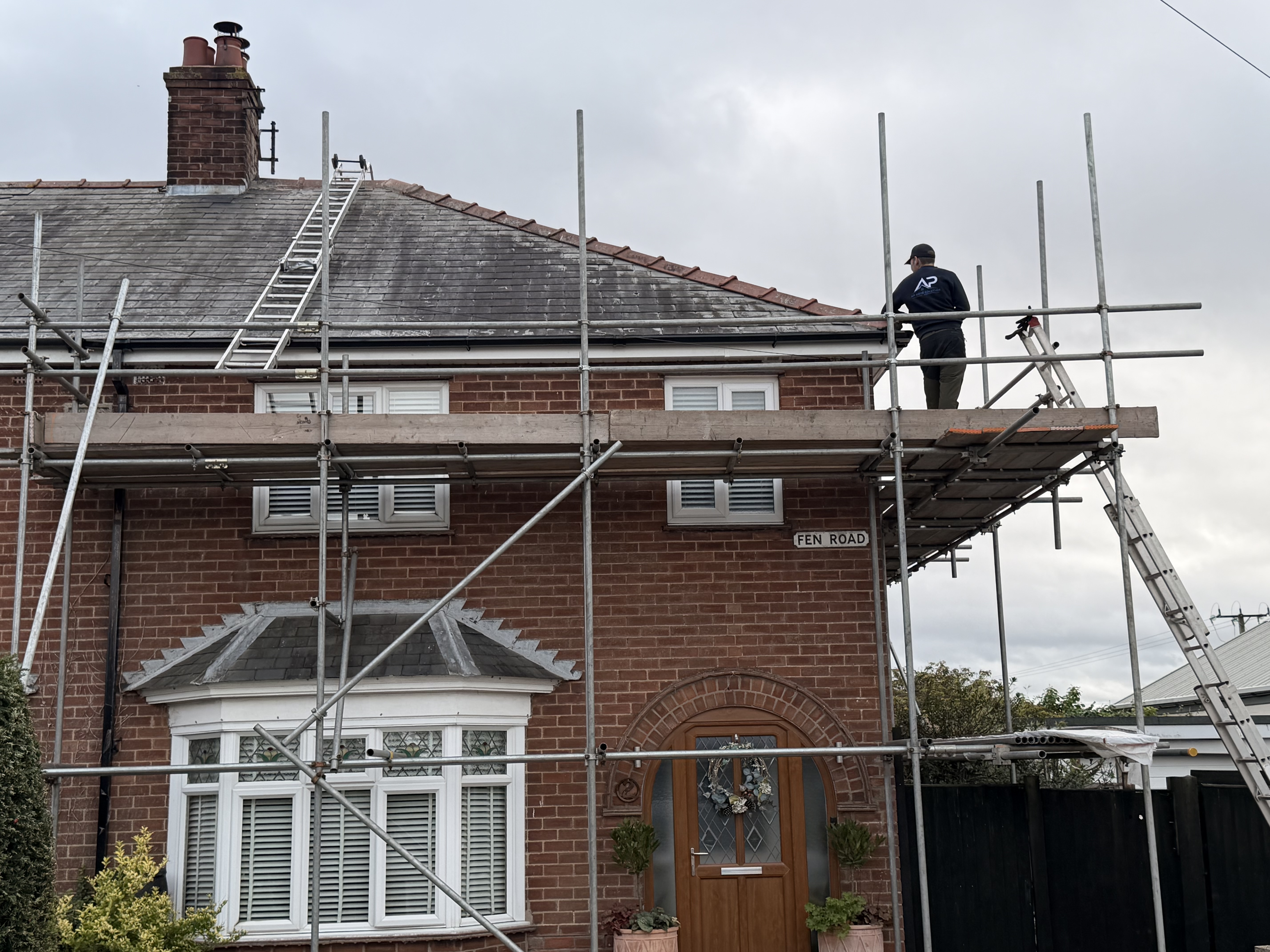 Scaffolded front elevation with roof work underway