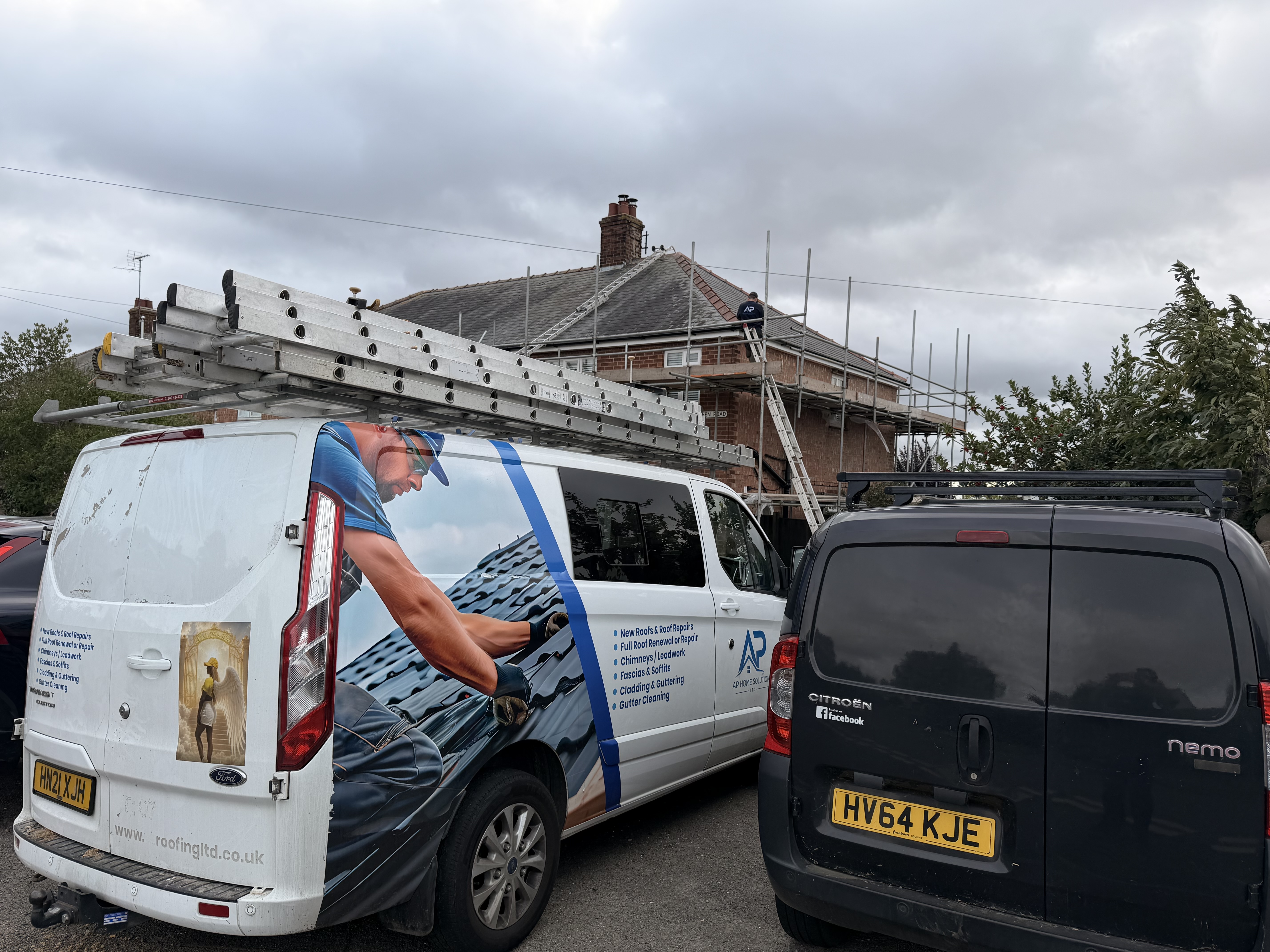 AP Home Solutions vehicle beside a scaffolded house