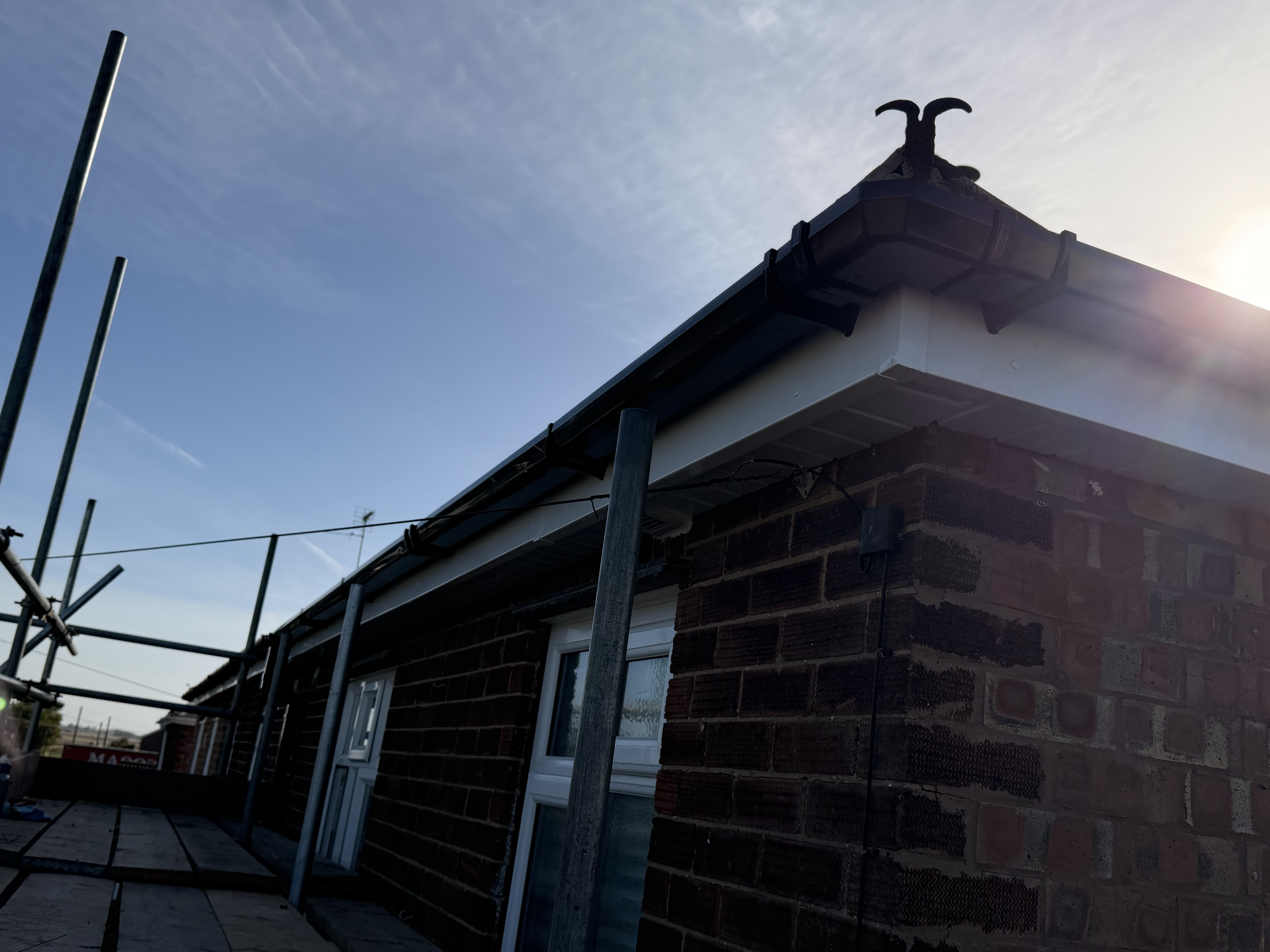 Brick gable and roof edge in strong sunlight