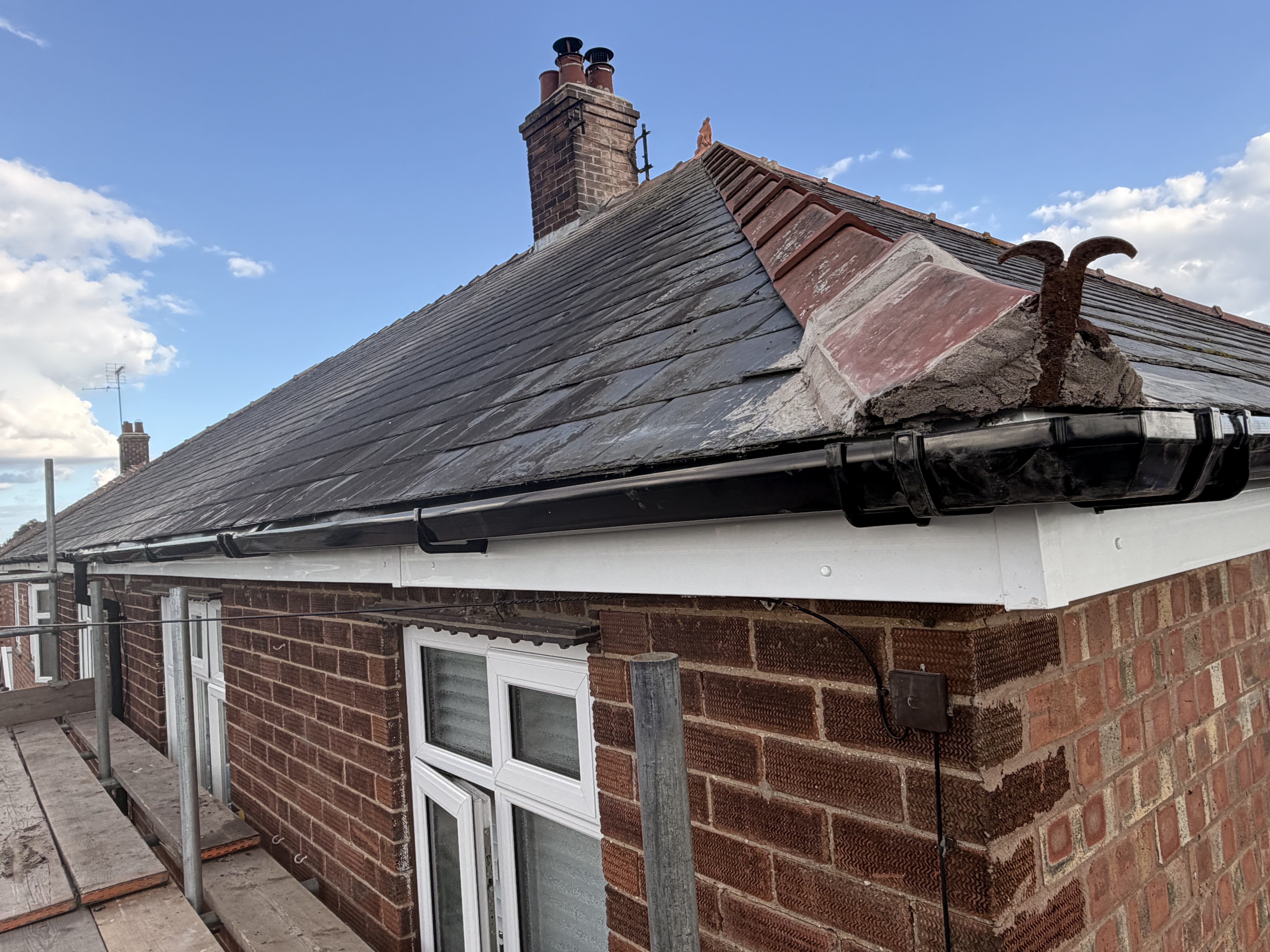 Completed slate roof with clean ridge and edge