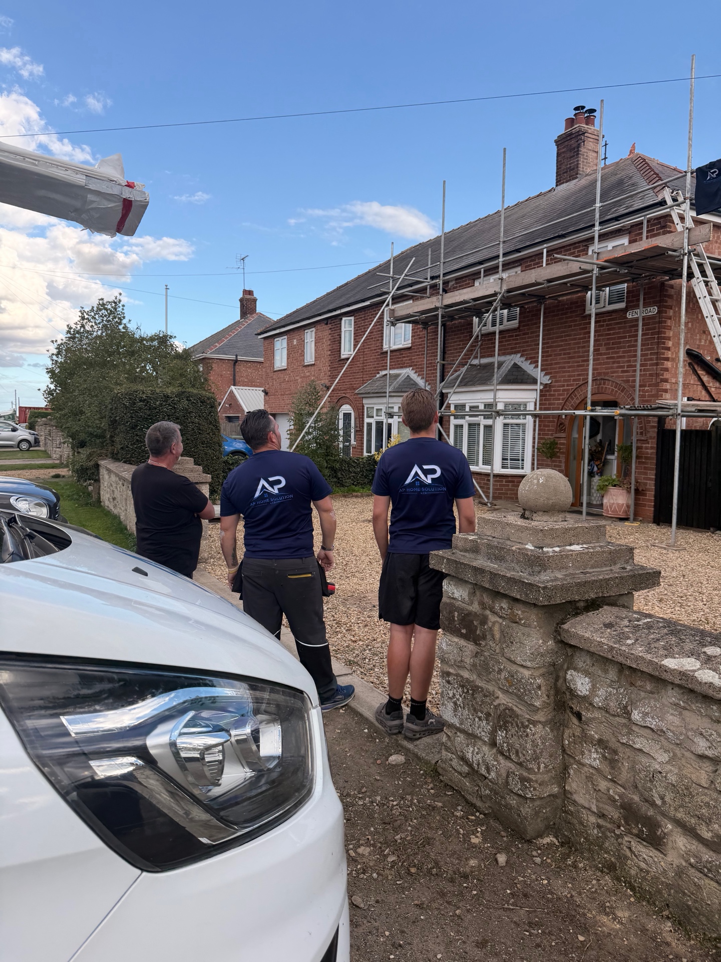 AP Home Solutions team beside the completed roofing project