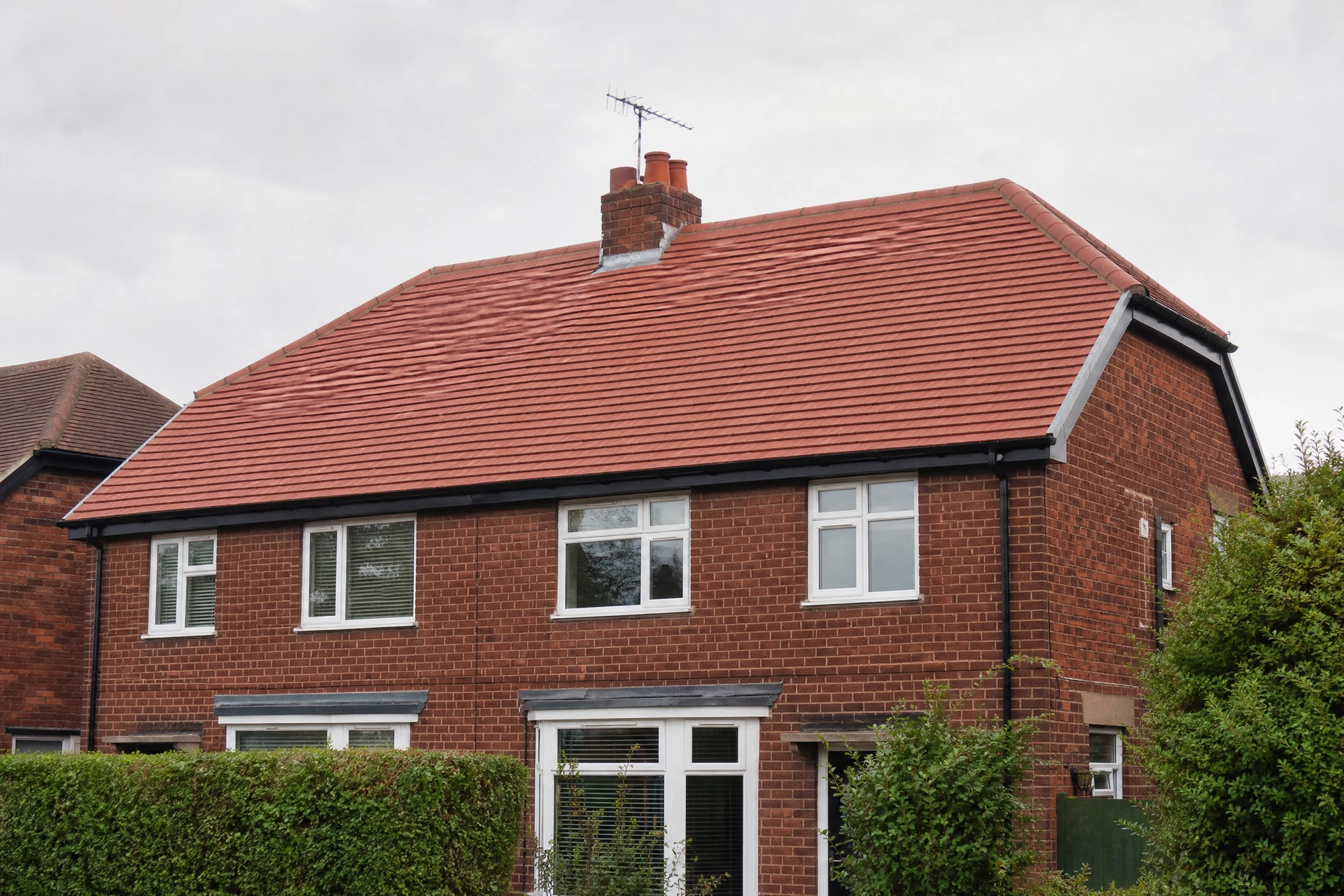 Representative view of a finished tiled roof on a British brick house